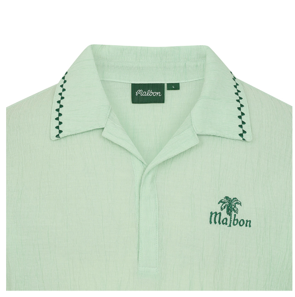 Malbon men's Textured Quick-Dry Lightweight Golf Polo in Navy Blue, logo and fabric detail